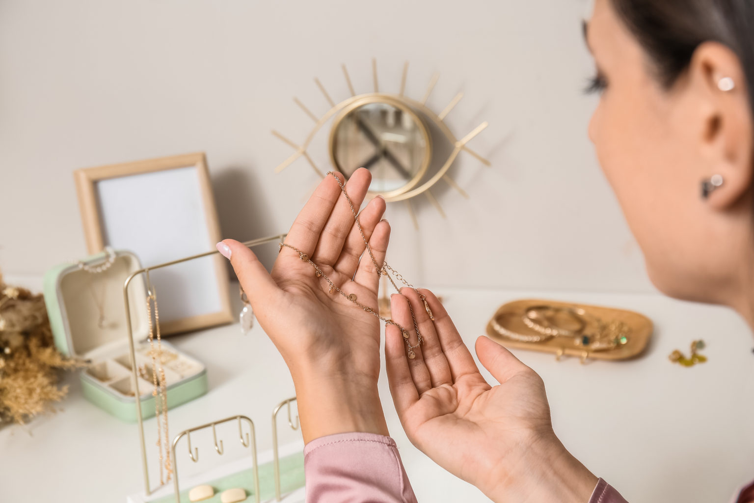 Gold Buyers Toowoomba Woman holding stylish necklace, closeup